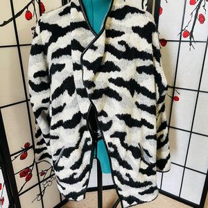Patterned cardigan with faux leather hem.